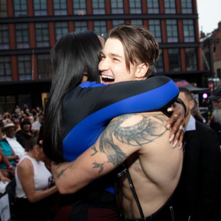 Two people embracing at the NYC premiere of THE STROLL during Meatpacking’s Movies on the Cobbles series in Gansevoort Plaza