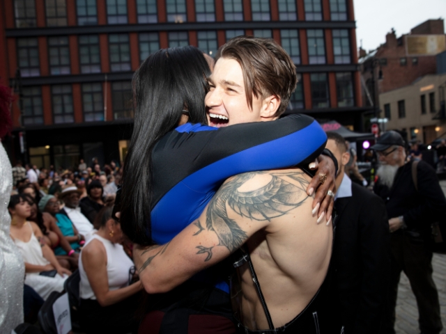 Two people embracing at the NYC premiere of THE STROLL during Meatpacking’s Movies on the Cobbles series in Gansevoort Plaza